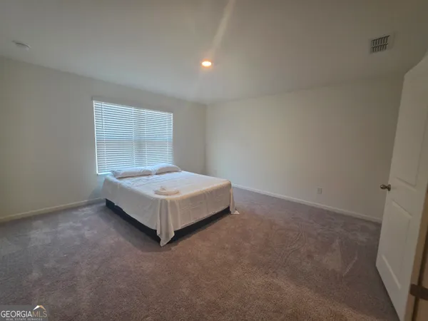 a bed sitting in a room next to a window