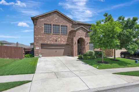 a front view of a house with yard