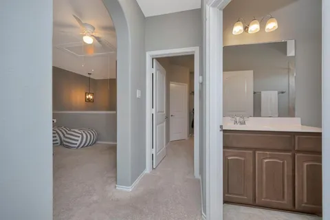 a bathroom with a sink a toilet and a large mirror
