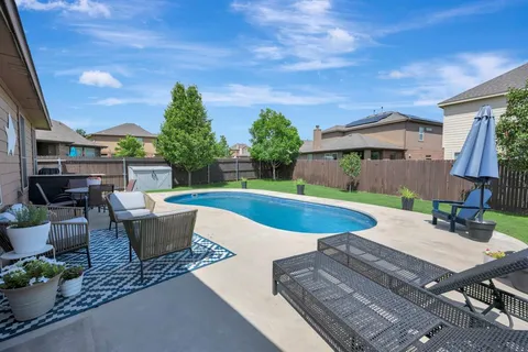 a view of a house with a yard patio and fire pit