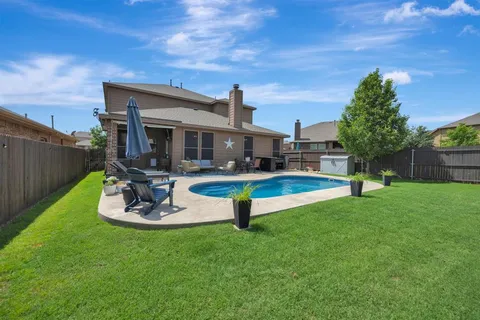 a outdoor living space with patio furniture and a rug