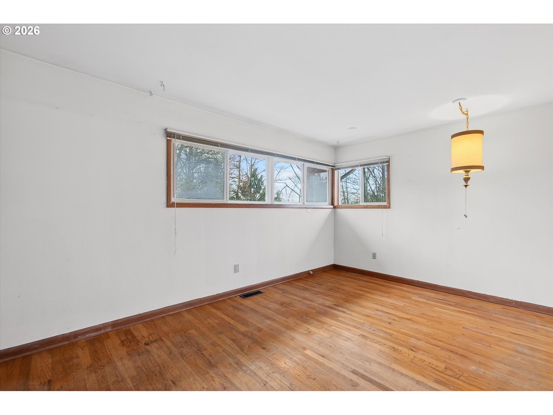 919 Cascade Drive Longview, WA 98632 - Photo 16 of 33 a view of an empty room with wooden floor and a window
