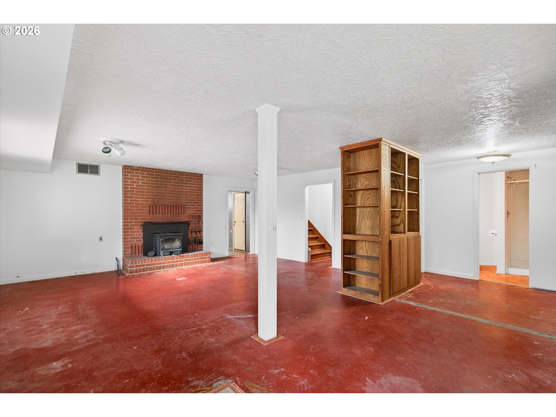 919 Cascade Drive Longview, WA 98632 - Photo 19 of 33 a view of empty room with fireplace and wooden floor
