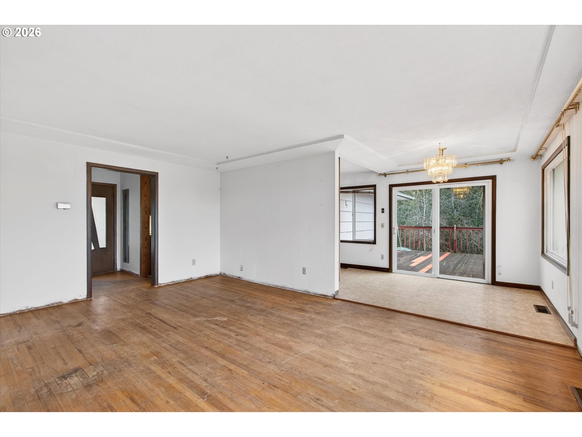 919 Cascade Drive Longview, WA 98632 - Photo 5 of 33 a view of an empty room with wooden floor and a window