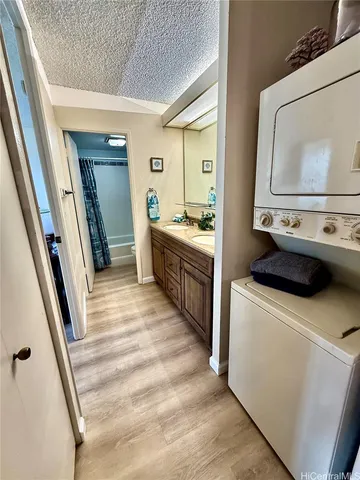 a spacious bathroom with a granite countertop sink and a mirror