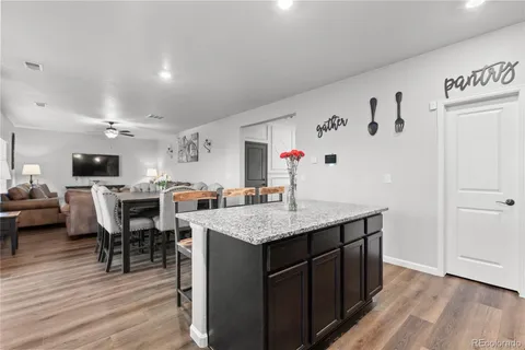 a kitchen with cabinets and wooden floor
