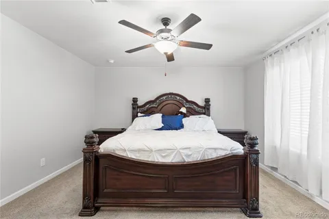 a bedroom with a bed and window