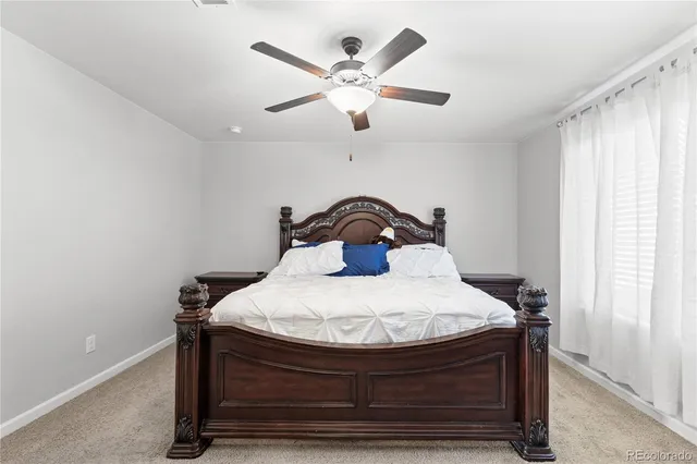 a bedroom with a bed and window