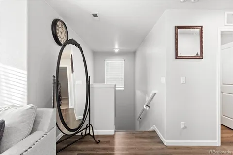 a view of a livingroom with furniture and a mirror