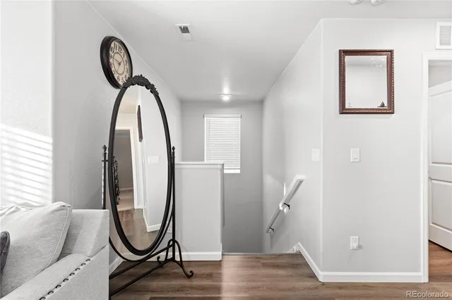 a view of a livingroom with furniture and a mirror