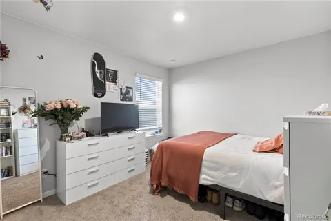 a bedroom with a bed and a potted plant