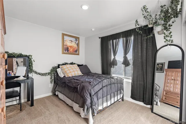 a bedroom with a bed couch and a window