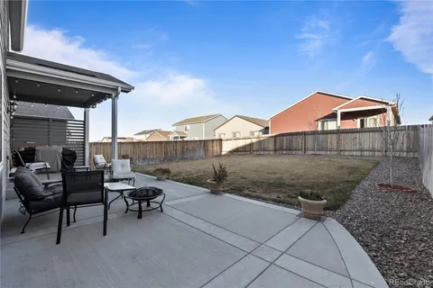 a backyard of a house with table and chairs