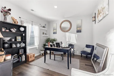 a living room with furniture a dining table and a large window
