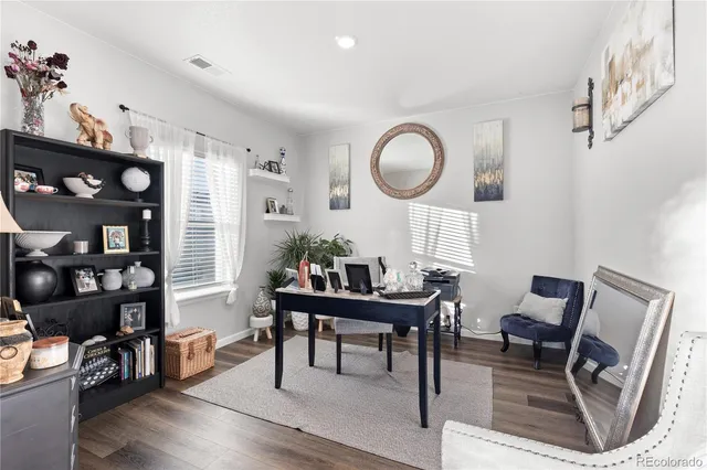 a living room with furniture a dining table and a large window