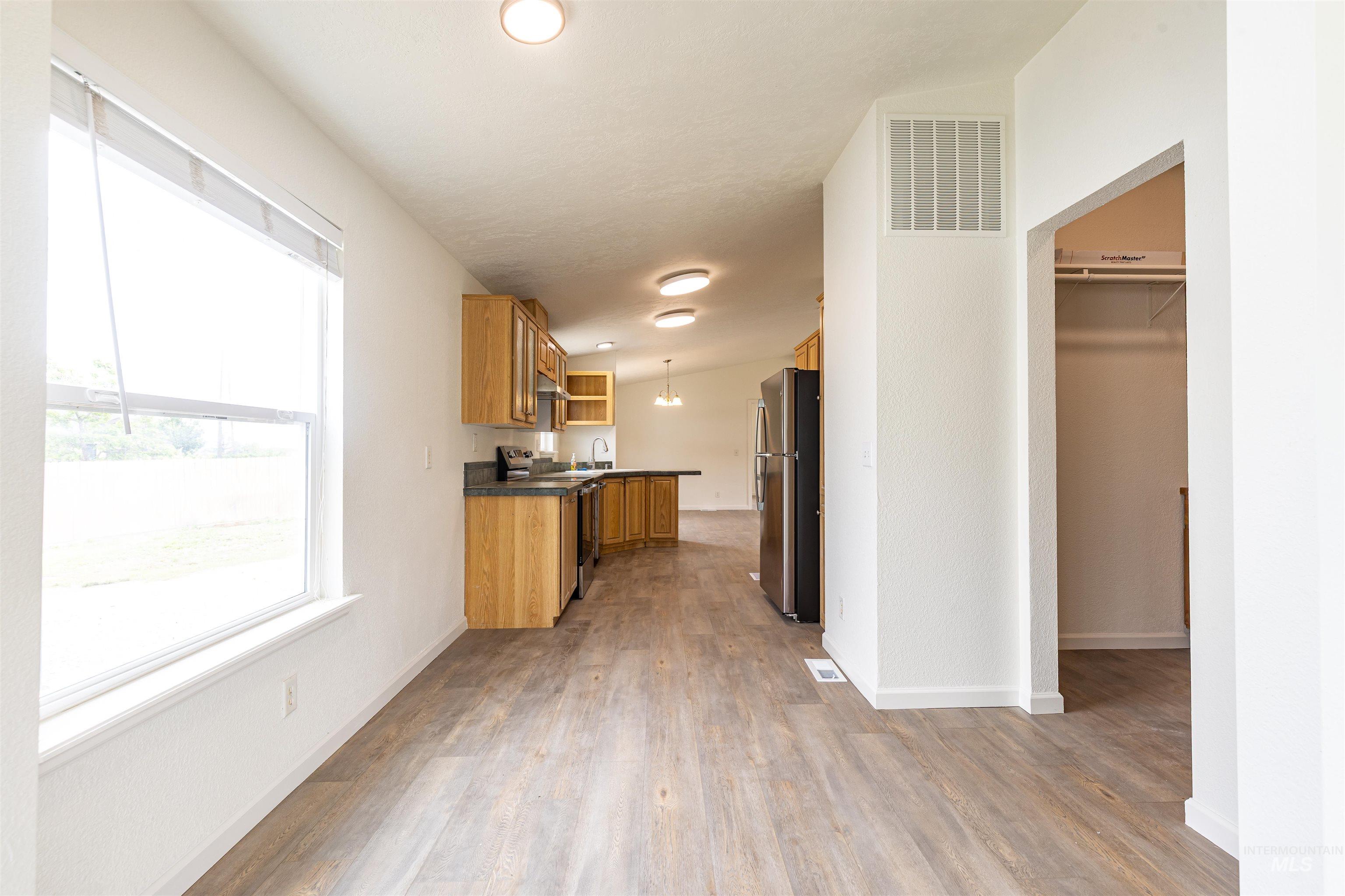17028 Lower Pleasant Ridge Road Caldwell, ID 83607 - Photo 16 of 21 Open-concept living area featuring wood-finish flooring