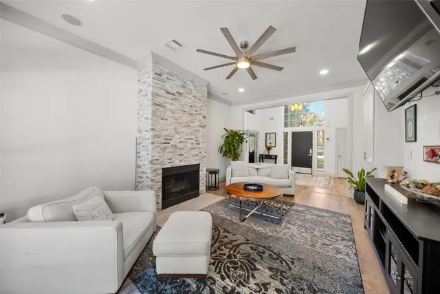 a living room with furniture a fireplace and a flat screen tv