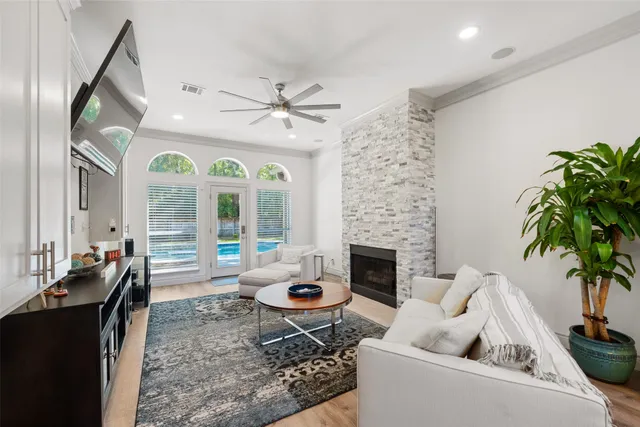 a living room with furniture fireplace and a large window