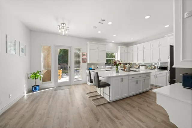 a kitchen with counter top space cabinets and wooden floor