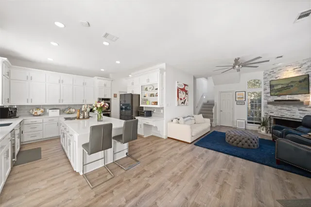 a large white kitchen with stainless steel appliances