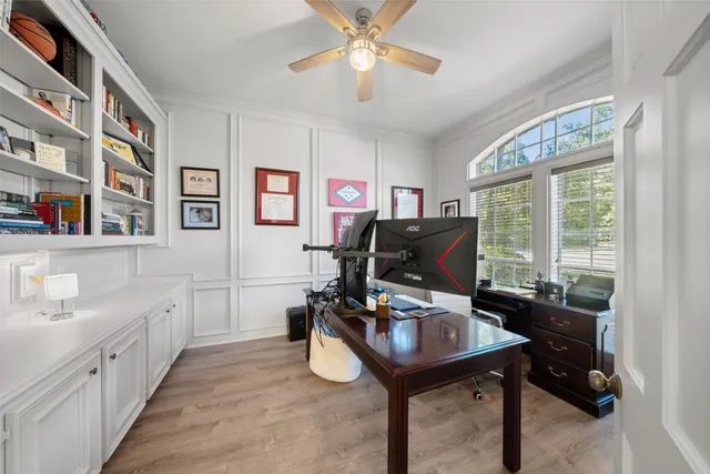 a view of a workspace with furniture and a window