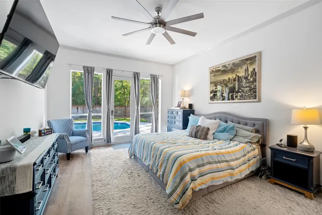 a bedroom with a bed a couch and a window