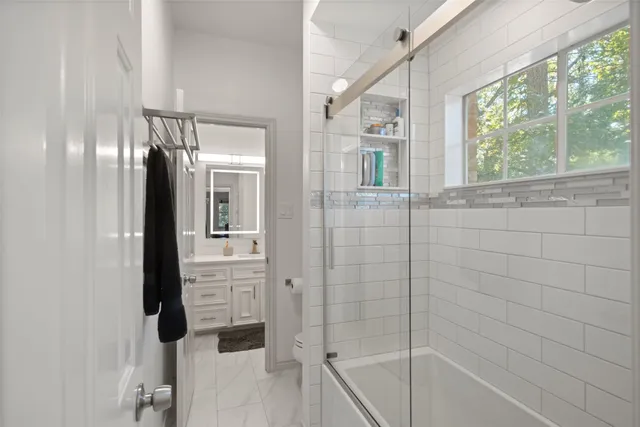 a bathroom with a bathtub and shower