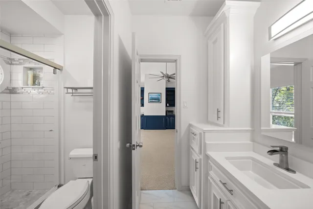 a bathroom with a sink toilet and shower