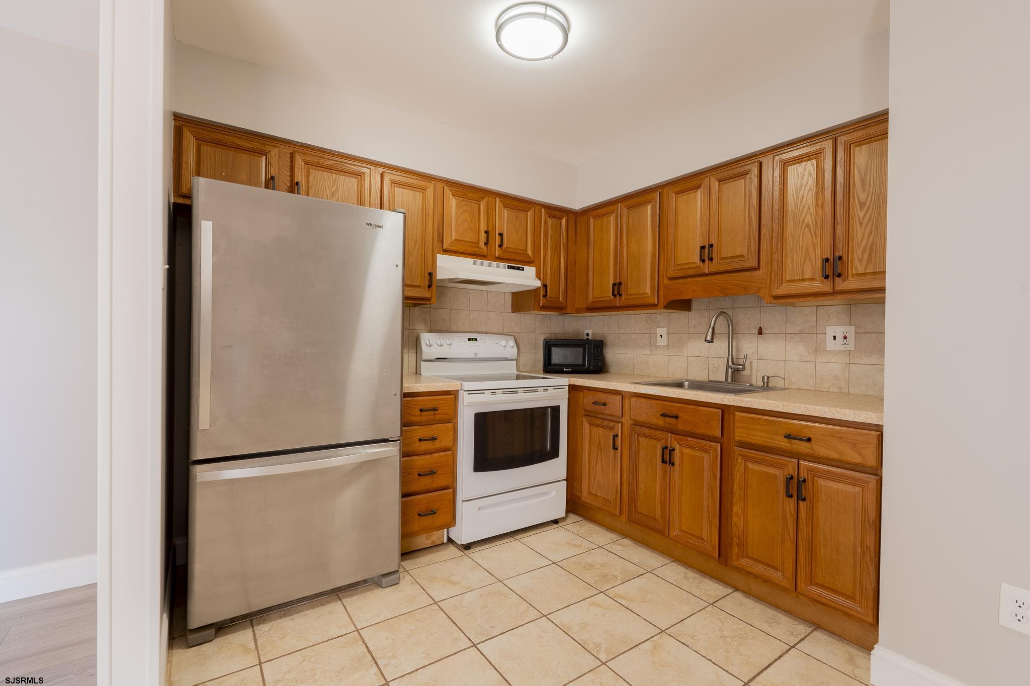 1137 South Beecham Road Williamstown, NJ 08094 - Photo 13 of 47 a kitchen with a refrigerator sink and cabinets