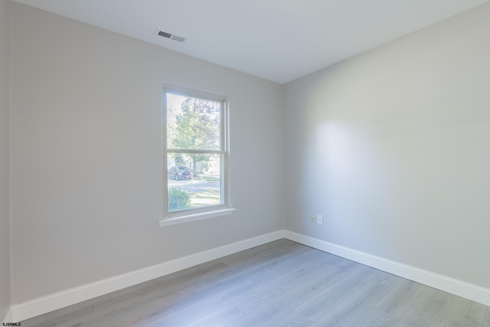 1137 South Beecham Road Williamstown, NJ 08094 - Photo 21 of 47 an empty room with wooden floor and windows