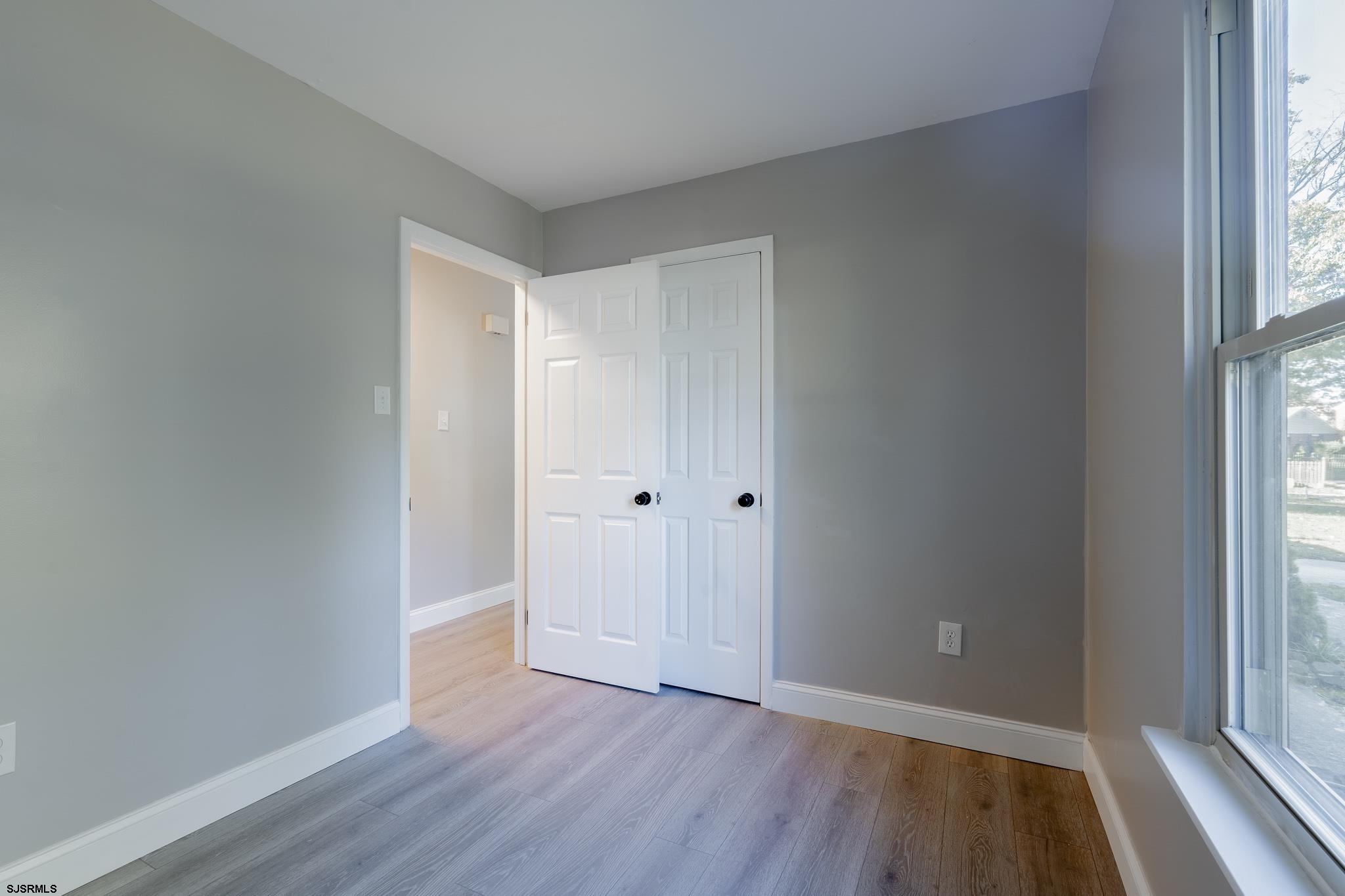 1137 South Beecham Road Williamstown, NJ 08094 - Photo 22 of 47 an empty room with wooden floor and windows