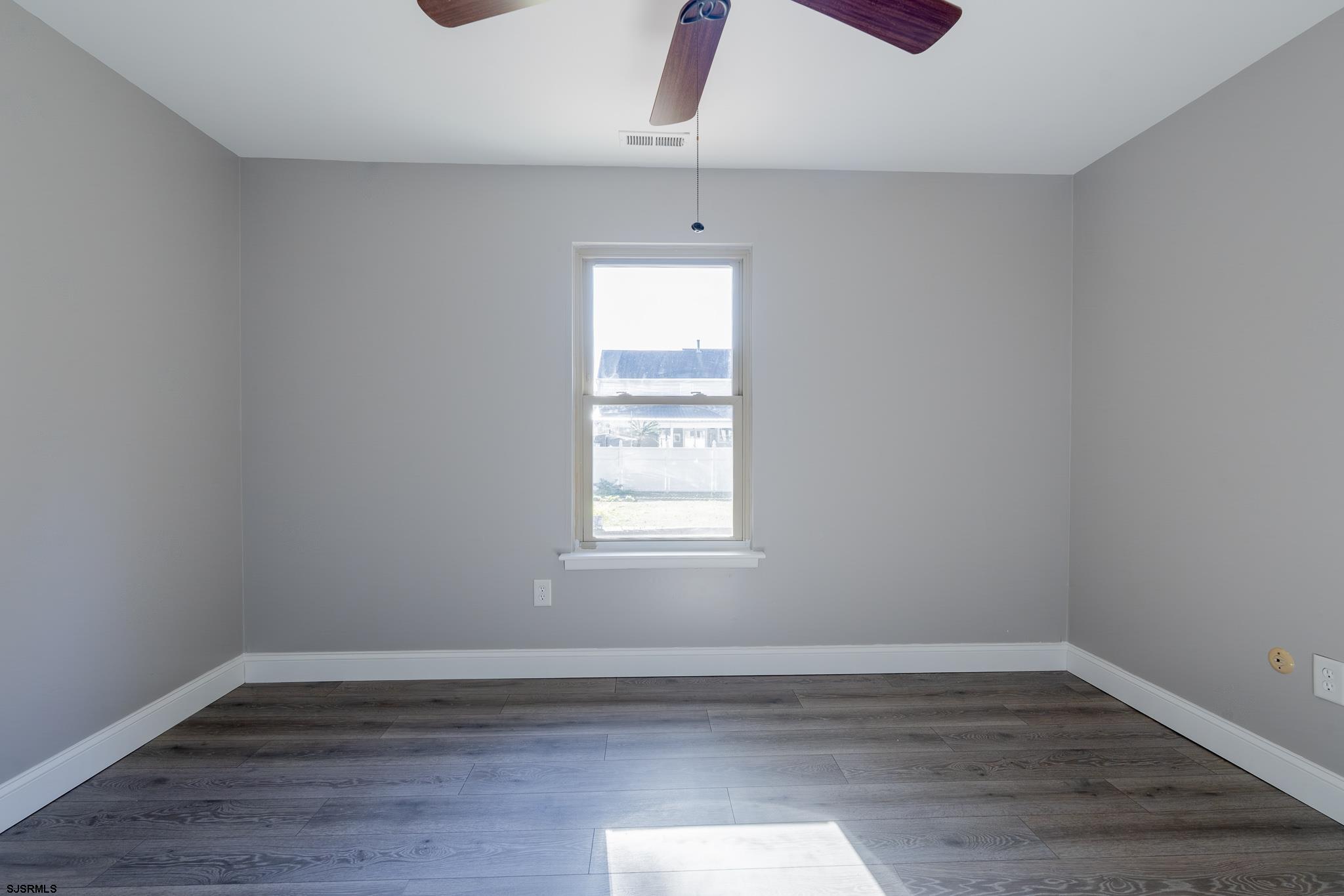 1137 South Beecham Road Williamstown, NJ 08094 - Photo 31 of 47 a view of an empty room with wooden floor and a window
