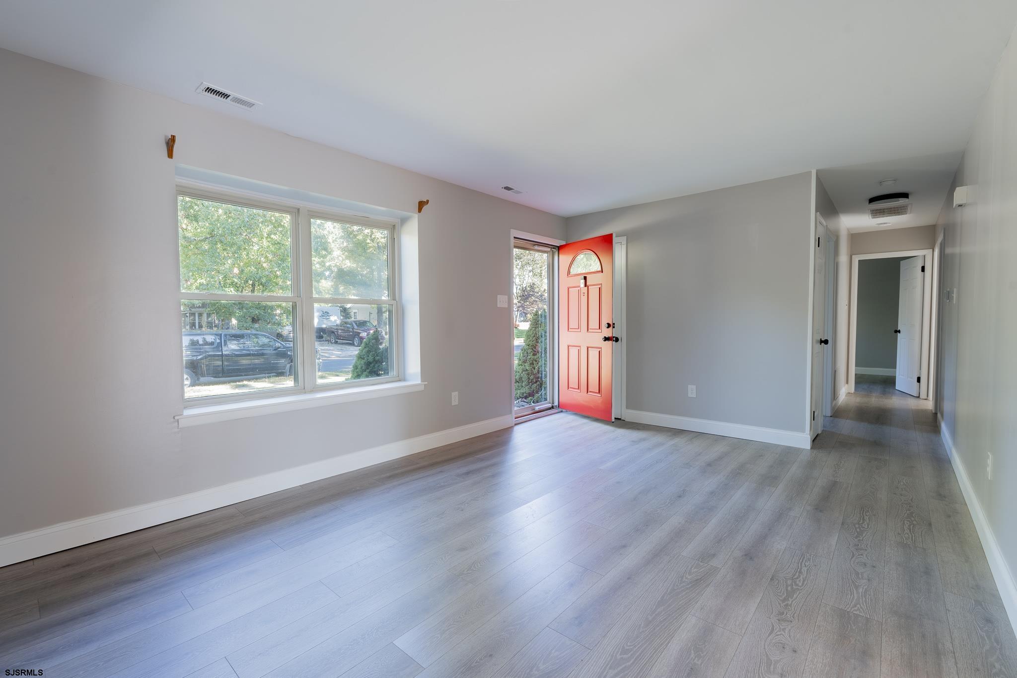 1137 South Beecham Road Williamstown, NJ 08094 - Photo 5 of 47 an empty room with wooden floor and windows
