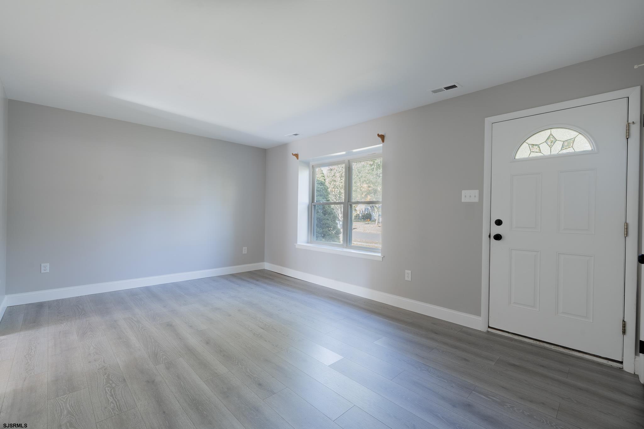 1137 South Beecham Road Williamstown, NJ 08094 - Photo 6 of 47 an empty room with wooden floor and window