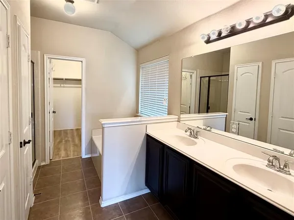 a bathroom with a double vanity sink a and mirror
