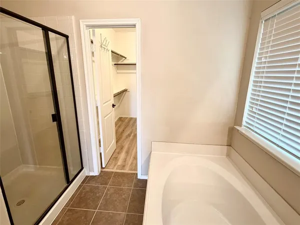 a bathroom with a tub and a shower