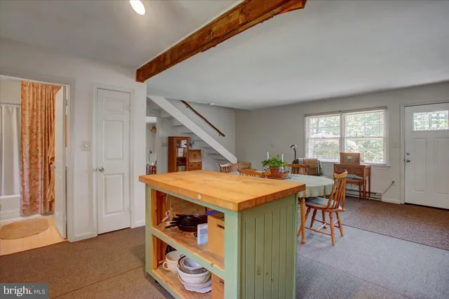 a large bed sitting in a bedroom next to a window
