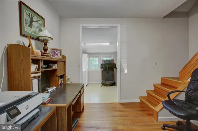 a view of backyard with swimming pool and trees in the background