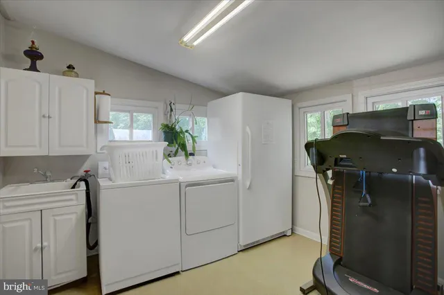 a living room with furniture a window and a flat screen tv