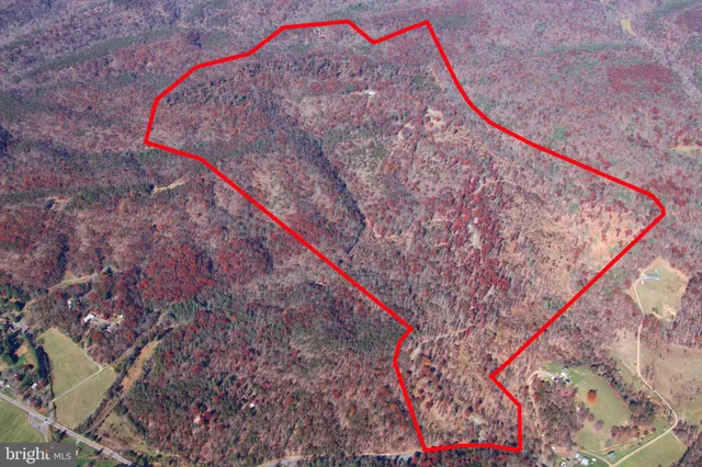an aerial view of a house with yard swimming pool and outdoor seating