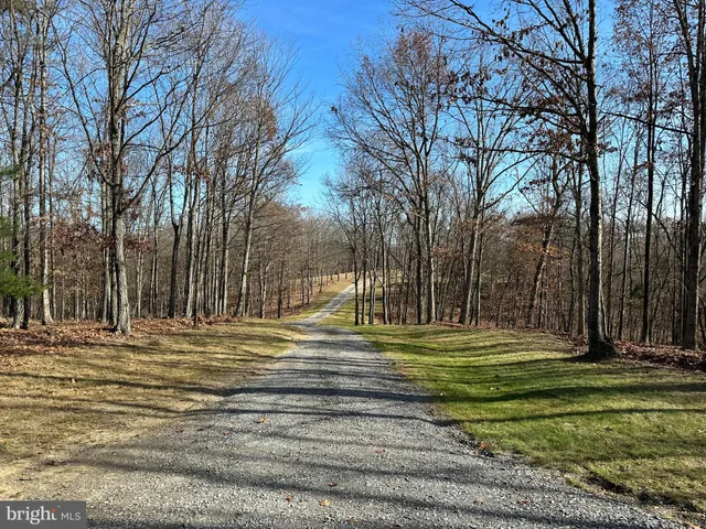 a view of a house with yard and sitting area