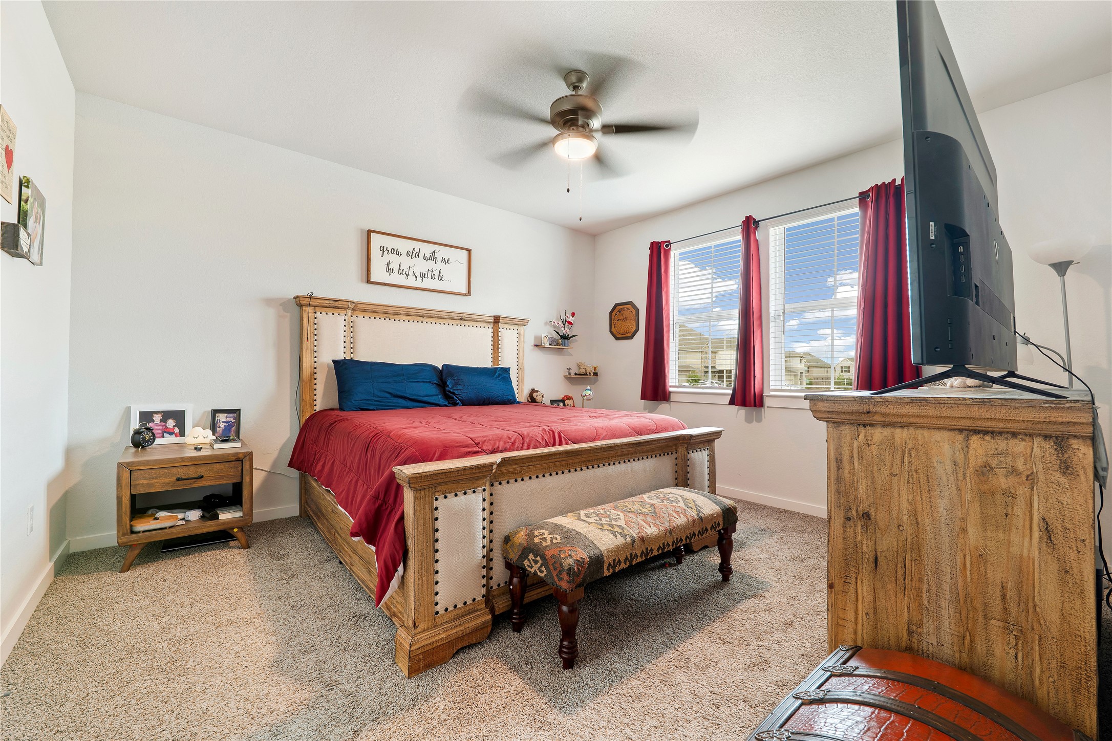 171 Acadia Drive Kyle, TX 78640 - Photo 13 of 26 Primary bedroom featuring carpet, a ceiling fan and baseboards