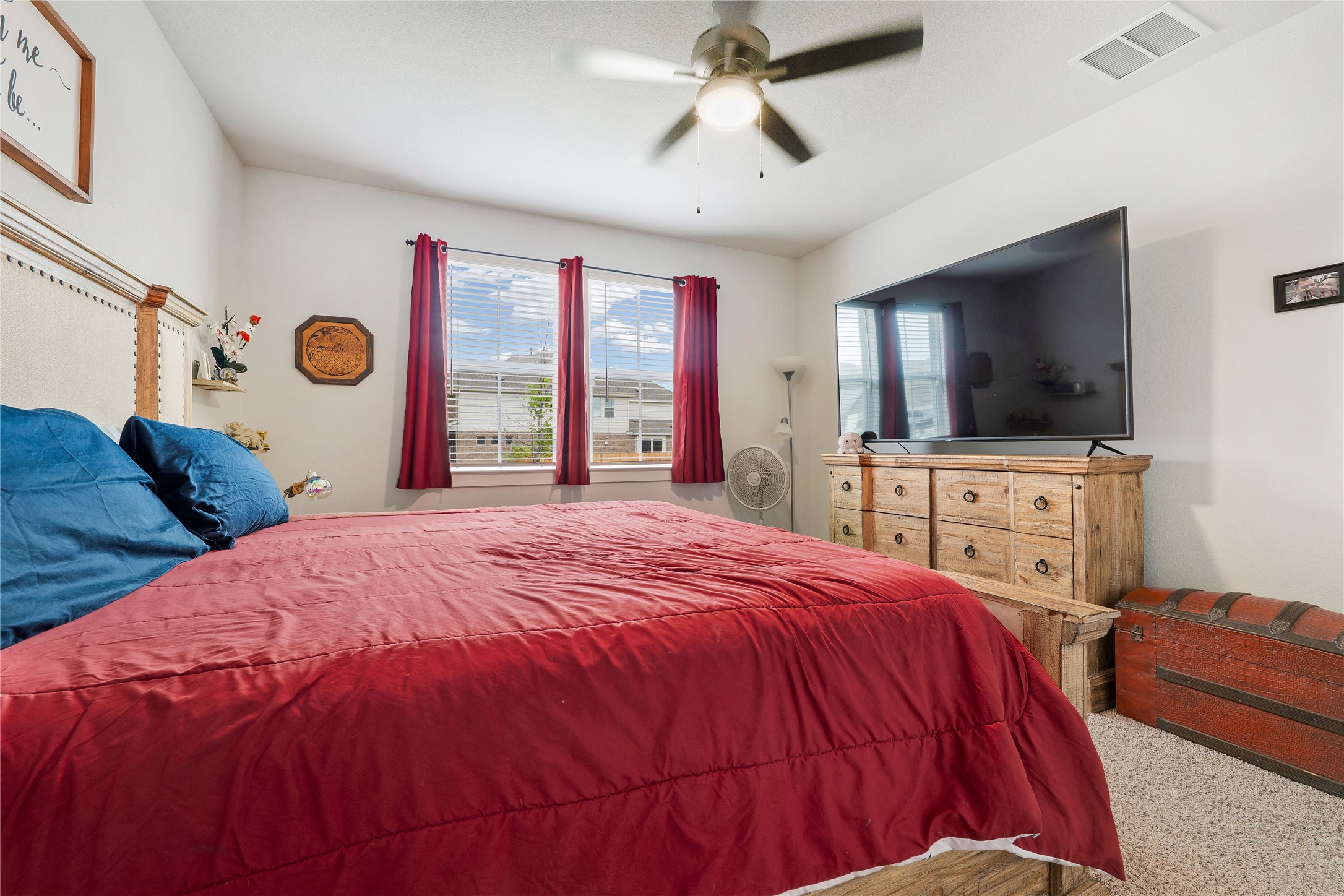 171 Acadia Drive Kyle, TX 78640 - Photo 14 of 26 Primary bedroom featuring carpet, a ceiling fan and baseboards