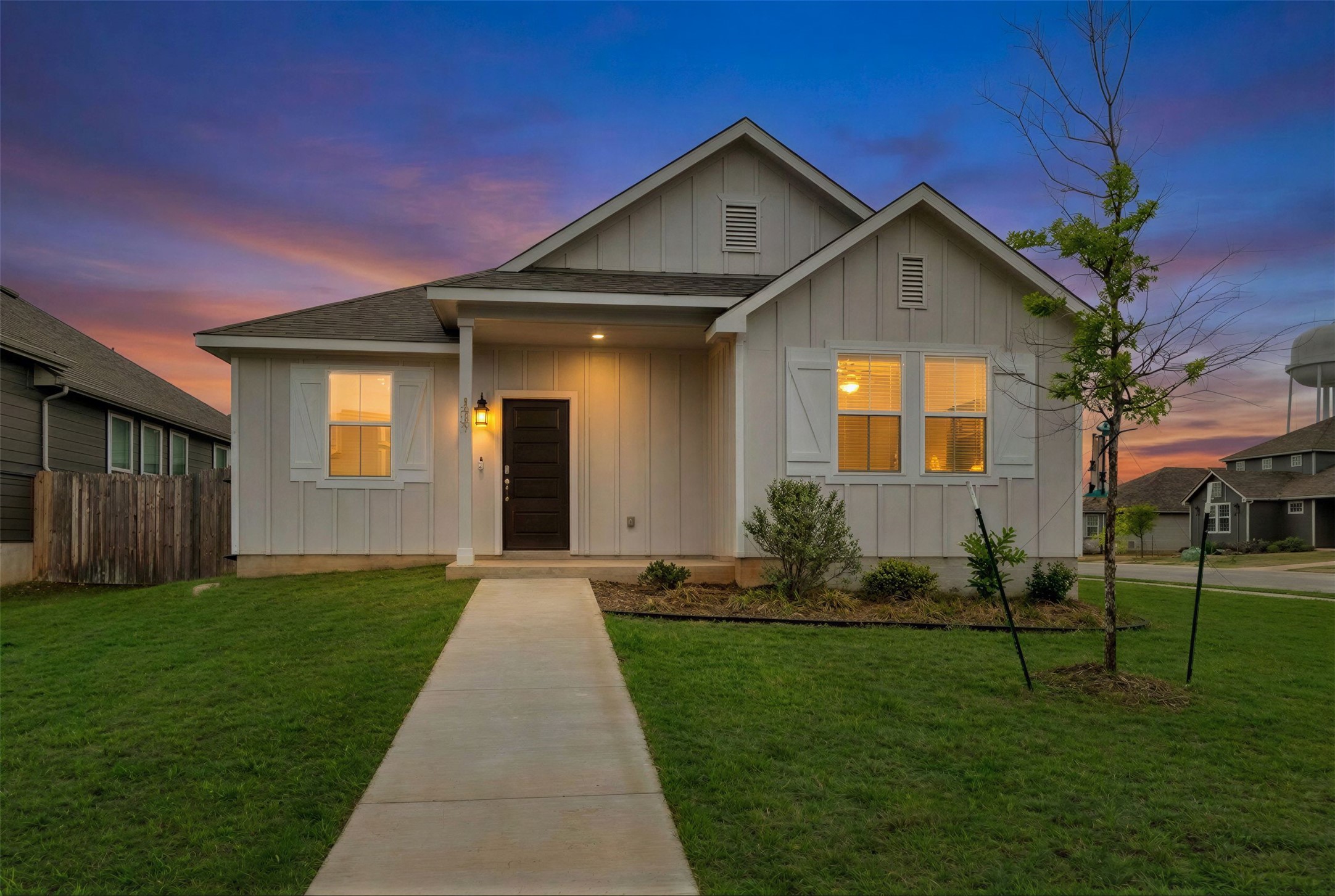 171 Acadia Drive Kyle, TX 78640 - Photo 19 of 26 View of front of home at dusk featuring board and batten siding and roof with shingles