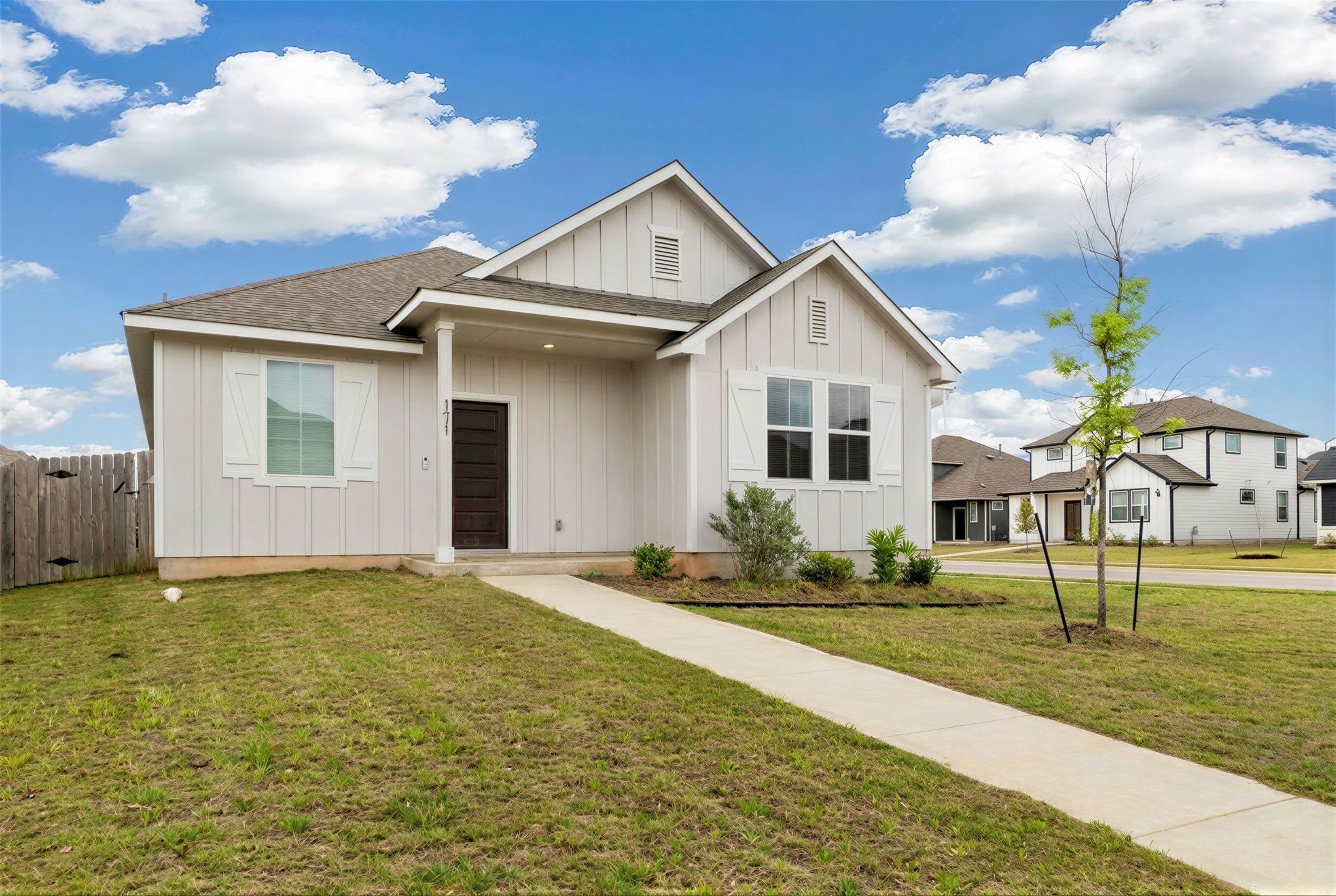 171 Acadia Drive Kyle, TX 78640 - Photo 20 of 26 View of front of home featuring board and batten siding and roof with shingles