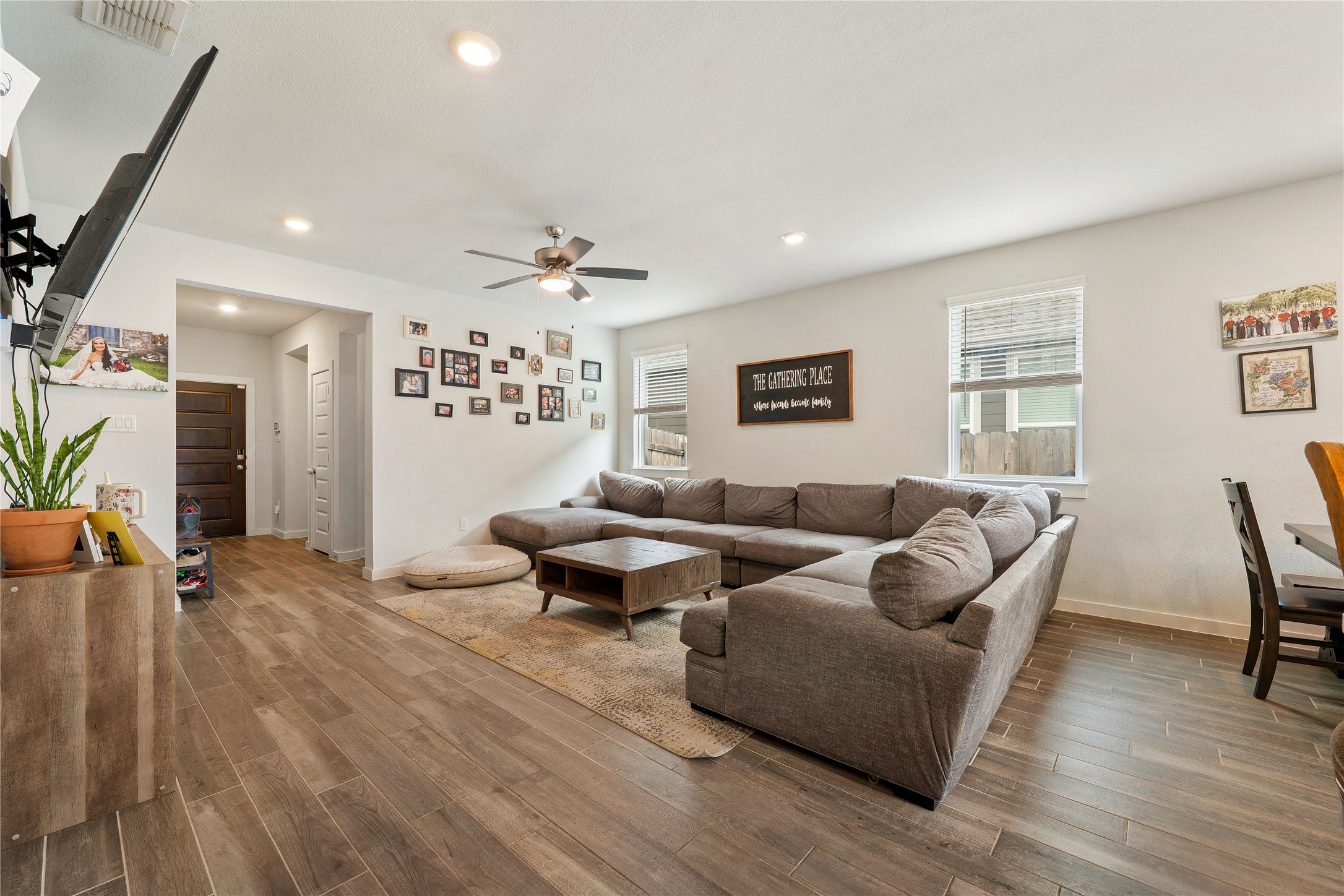 171 Acadia Drive Kyle, TX 78640 - Photo 3 of 26 Living area with healthy amount of natural light, wood finished flooring, recessed lighting, and ceiling fan