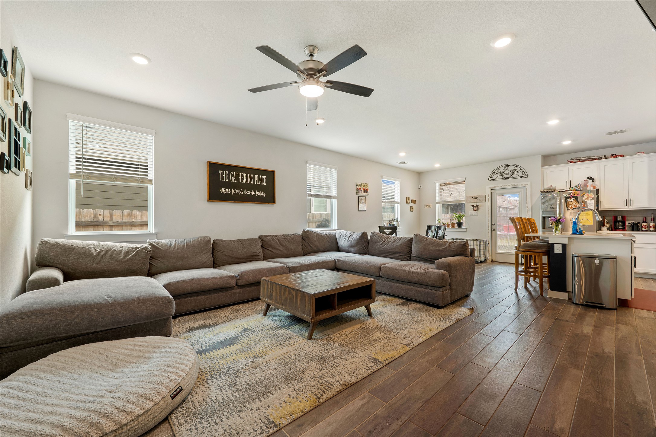 171 Acadia Drive Kyle, TX 78640 - Photo 4 of 26 Living area with healthy amount of natural light, wood finished flooring, recessed lighting, and ceiling fan
