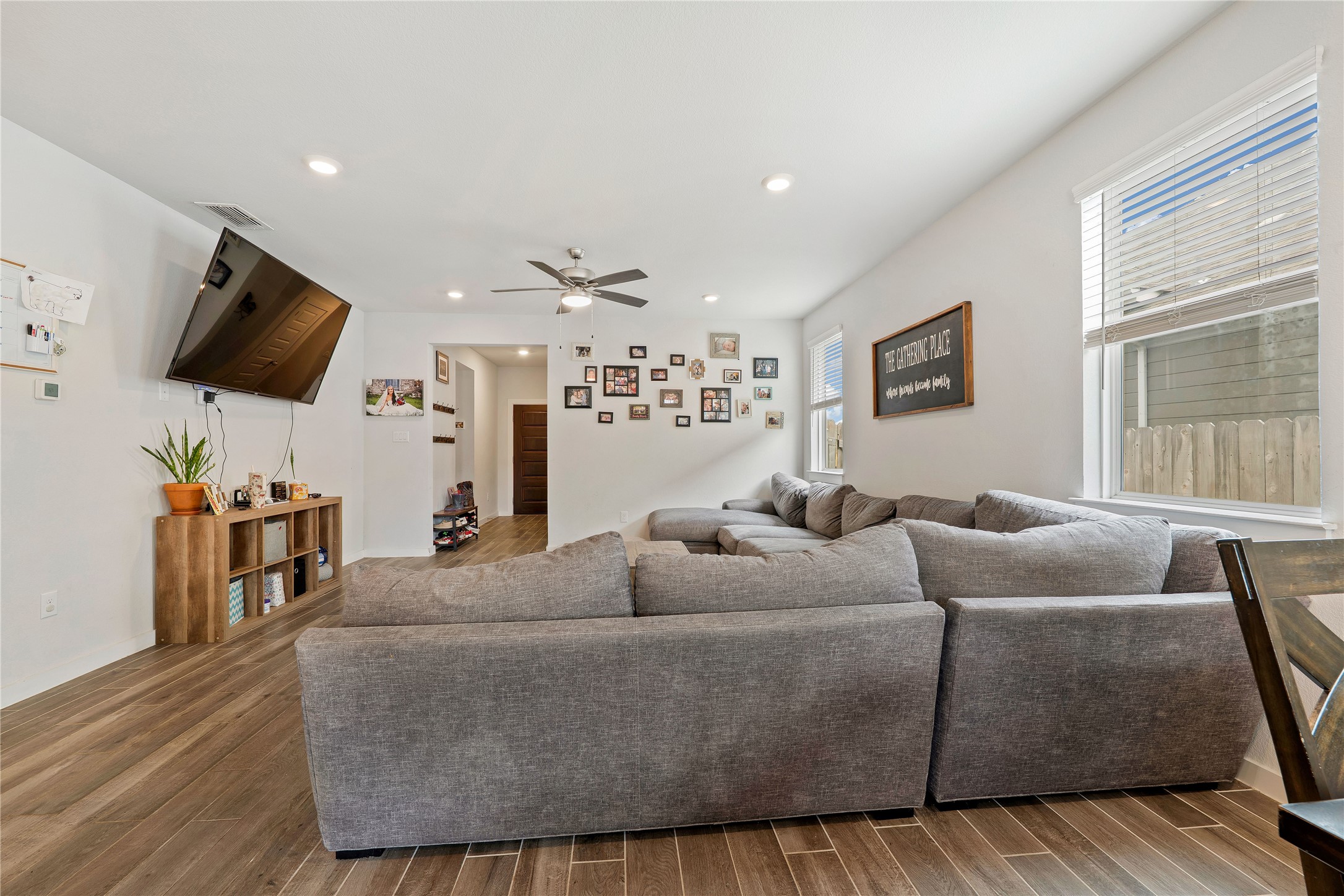 171 Acadia Drive Kyle, TX 78640 - Photo 5 of 26 Living area with healthy amount of natural light, wood finished flooring, recessed lighting, and ceiling fan