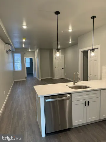 a kitchen with kitchen island a sink and a stove top oven