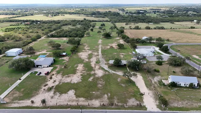 an aerial view of a houses with outdoor space
